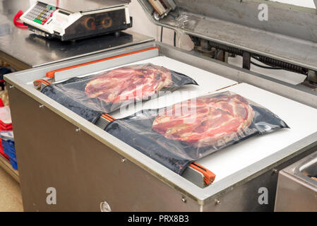Vacuum heat sealing machine for food package Stock Photo - Alamy