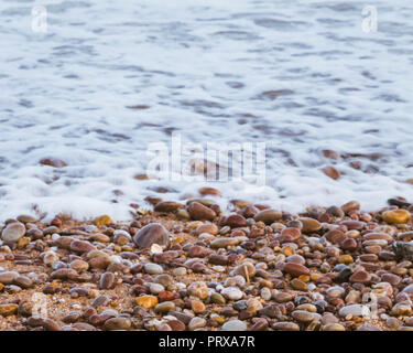 The incoming tide onto the pebbled beach at Budleigh Salterton, East Devon, South West England, United Kingdom. Stock Photo