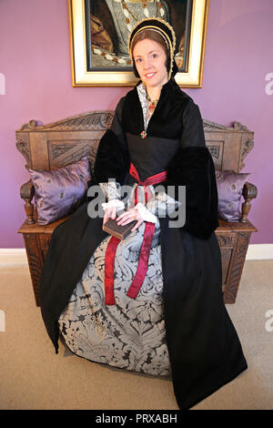 Young woman dressed in Tudor period costume holding Holy Bible Stock Photo