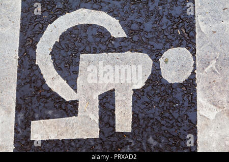 Weird disabled parking sign painted on a road Stock Photo