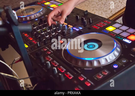 Professional concert dj turntables player device with sound mixer panel and jog wheel.Club disc jockey stage equipment for playing music on party.Digital turn table deck for nightclub Stock Photo