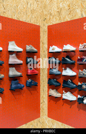 Display with Sneakers on the shelves in shoes store Stock Photo