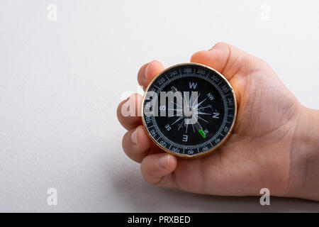 Compass tool in toddler hand on white Stock Photo