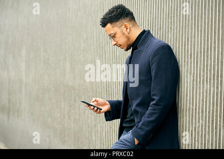 Side view of businessman using smartphone Stock Photo