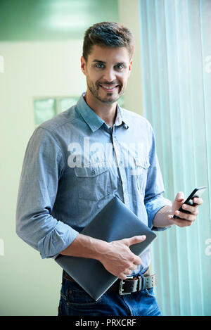 Portrait of engineer standing in office Stock Photo