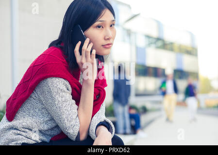 Young woman talking on smartphone Stock Photo