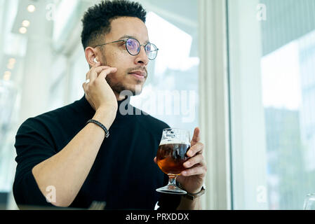 Thoughtful businessman having drink Stock Photo