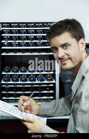 Portrait of engineer holding clipboard Stock Photo
