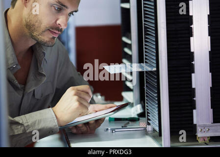 Close-up of engineer looking at chip in office Stock Photo