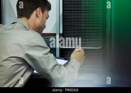 Close-up of engineer inserting chip into machine Stock Photo
