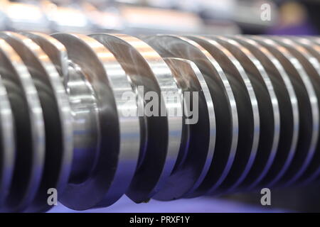 Screw press parts for plastic injection machine ; selective focus Stock Photo