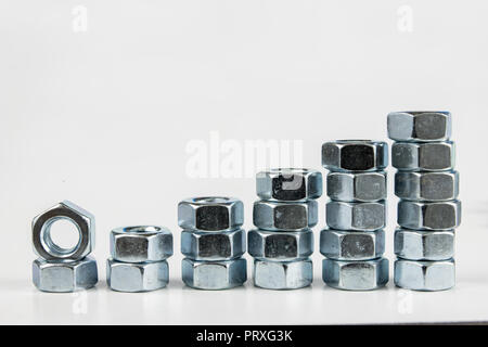 Chrome caps on a white table. Accessories for mounting steel structures on a workshop table. White background. Stock Photo