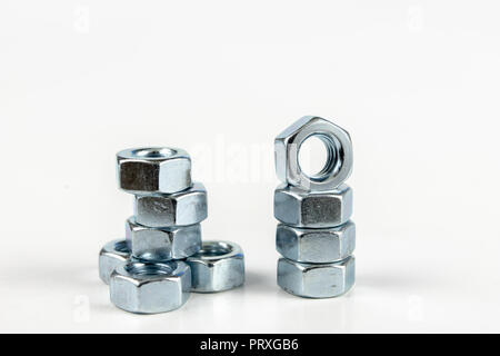 Chrome caps on a white table. Accessories for mounting steel structures on a workshop table. White background. Stock Photo