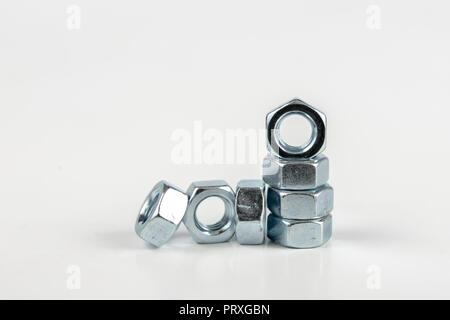 Chrome caps on a white table. Accessories for mounting steel structures on a workshop table. White background. Stock Photo