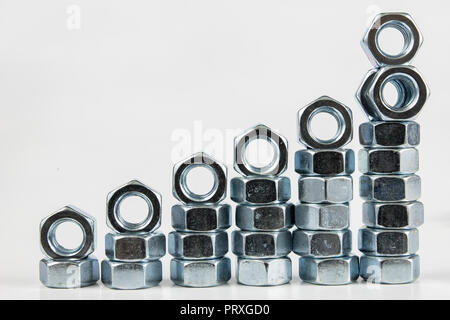 Chrome caps on a white table. Accessories for mounting steel structures on a workshop table. White background. Stock Photo