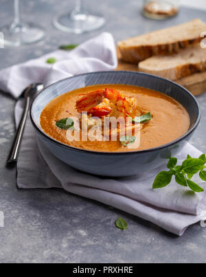 Portion of creamy vegetable soup with shrimps Stock Photo