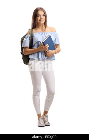 Full length portrait of a female student with a backpack and books isolated on white background Stock Photo
