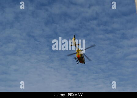 Helicopter start in blue sky with clouds emergency call helicopter Stock Photo