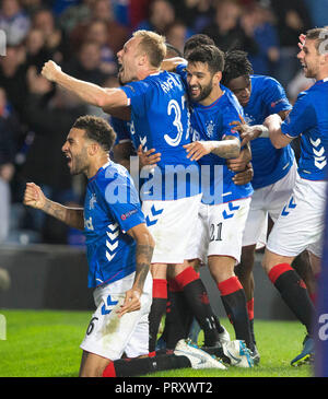 Rangers James Tavernier (obscured) celebrates scoring his side's second goal of the game from the penalty spot with team-mates during the UEFA Europa League, Group G match at Ibrox Stadium, Glasgow. Stock Photo