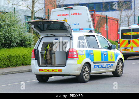 Police vehicles attending a crime scene , where the suspect was thought to be hiding in an industrial area of Garforth,West Yorkshire. Stock Photo