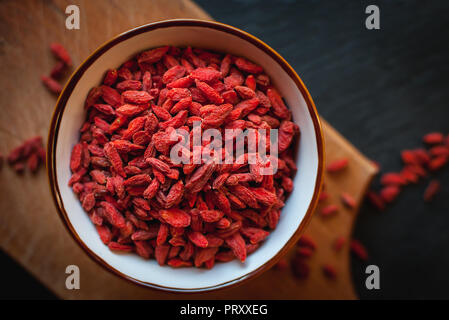 Close-up of dried goji berries in bowl on dark background Stock Photo