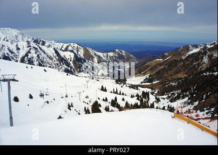 high snowy mountains in cloudy day, mounting skiing resort Shymbulak or Chimbulak, Almaty, Kazakhstan Stock Photo