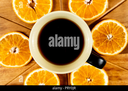 Orange Slices On Wooden Cutting Board and a mug of coffe Stock Photo