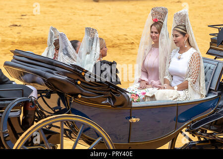 Seville, Spain - April  15, 2018: Women carries the traditional spanish head coverage called mantilla in a Horse drawn carriage in Seville April Fair  Stock Photo