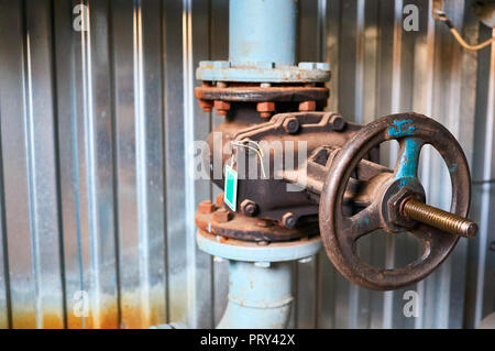 Old valves on the cold water pipeline. Industrial background. Stock Photo