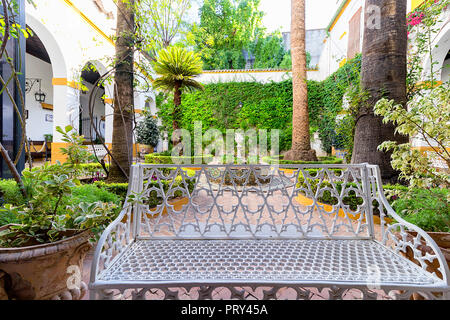 Seville, Spain - October 28, 2017: Typical Andalusian bench in Courtyard of Palace of the Dukes of Alba or Palacio de las Duenas Stock Photo