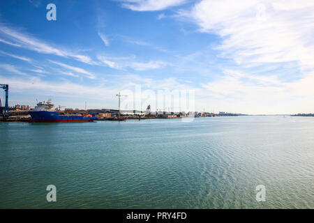 Landscape of port of Huelva with cranes, fishing boat in shipyard and mall in coast of Huelva, Andalusia, Spain. Stock Photo