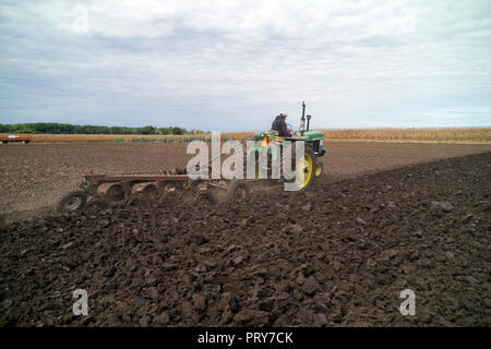 A John Deere model A tractor pulling a plow Stock Photo - Alamy
