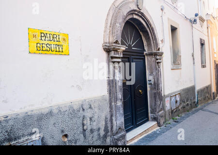 Old arch arched vintage ornate wooden panelled door, Vico Equense, Italy Stock Photo