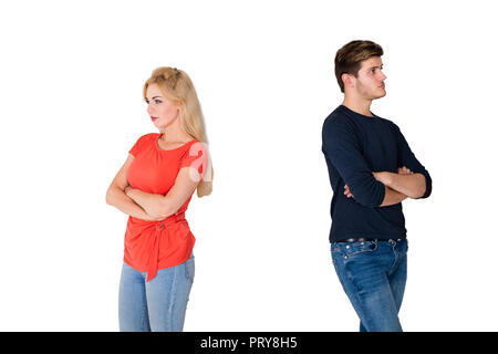 Upset Young Couple Standing Back To Back On White Background Stock Photo