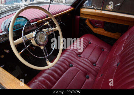RUSSIA, TAGANROG, 09 MAY 2018: Red leather seat and dashboard of car GAZ-21 Volga. View from the drivers side Stock Photo