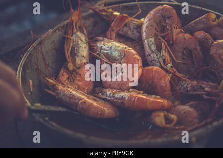 Tasty appetizing large shrimps in sauce with dill and lemon. Toned image Stock Photo
