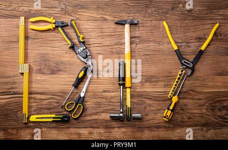 DIY Word Made Up Of Different Worktools On Wooden Surface Stock Photo