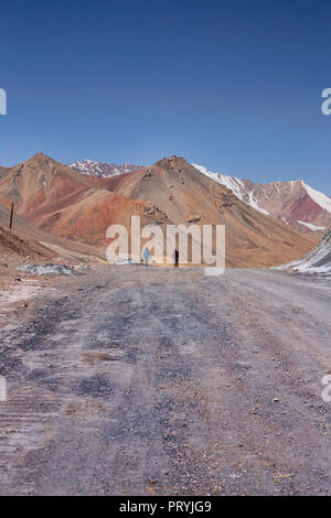 Tourists on the 4,655 meter Ak-Baital Pass on the remote Pamir Highway, Gorno-Badakhshan Autonomous Region, Tajikistan. Stock Photo