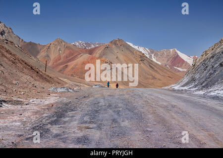 Tourists on the 4,655 meter Ak-Baital Pass on the remote Pamir Highway, Gorno-Badakhshan Autonomous Region, Tajikistan. Stock Photo