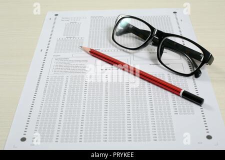 Picture of omr sheet, glasses and pencil. Isolated on white background. Stock Photo