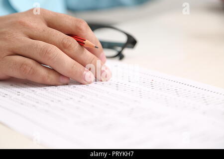 Picture of hand on the OMR sheet with pencil. Stock Photo
