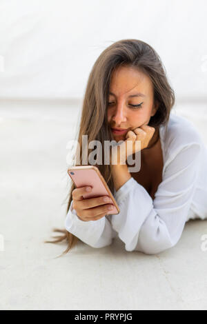 Portrait of young woman looking at cell phone Stock Photo