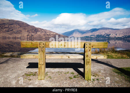 United Kingdom, Scotland, view of a loch, empty wooden bench Stock Photo