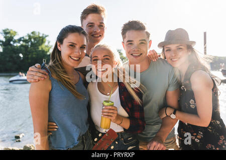 Portrait of group of happy friends at the riverside Stock Photo