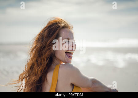 Laughing woman having fun on the beach Stock Photo