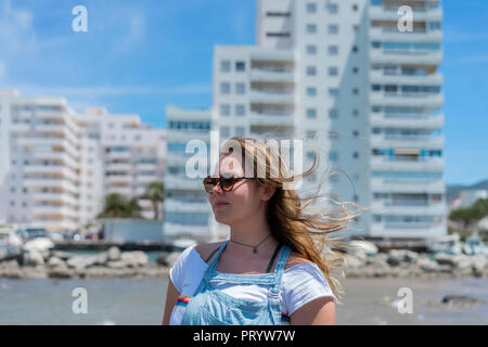 Young woman at the beach, wearing sunglasses, portrait Stock Photo