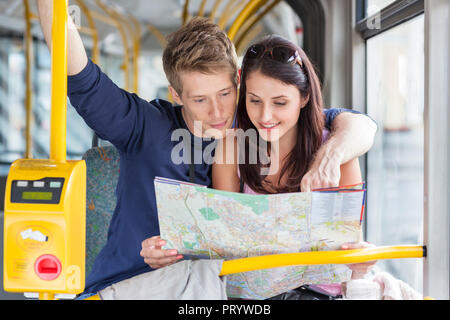 Poland, Warsaw, Young couple in bus reading city map Stock Photo