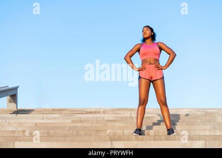 Young woman during workout on stairs Stock Photo