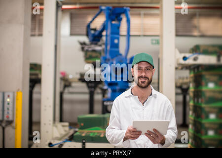 Worker using tablet in factory Stock Photo