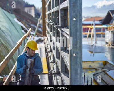 Construction worker working on plywood Stock Photo